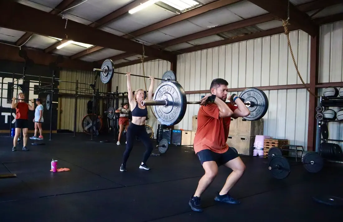 Black Wolf CrossFit members lifting barbells in the Houston gym